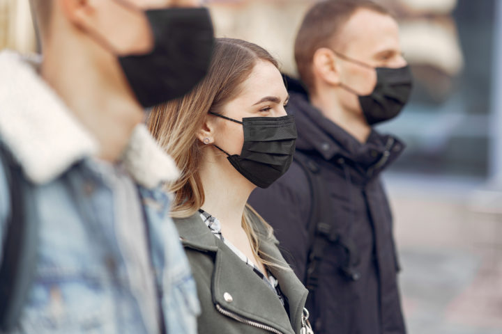 People in the city. Persons in a masks. Coronavirus theme. Friends walks during quarantine.